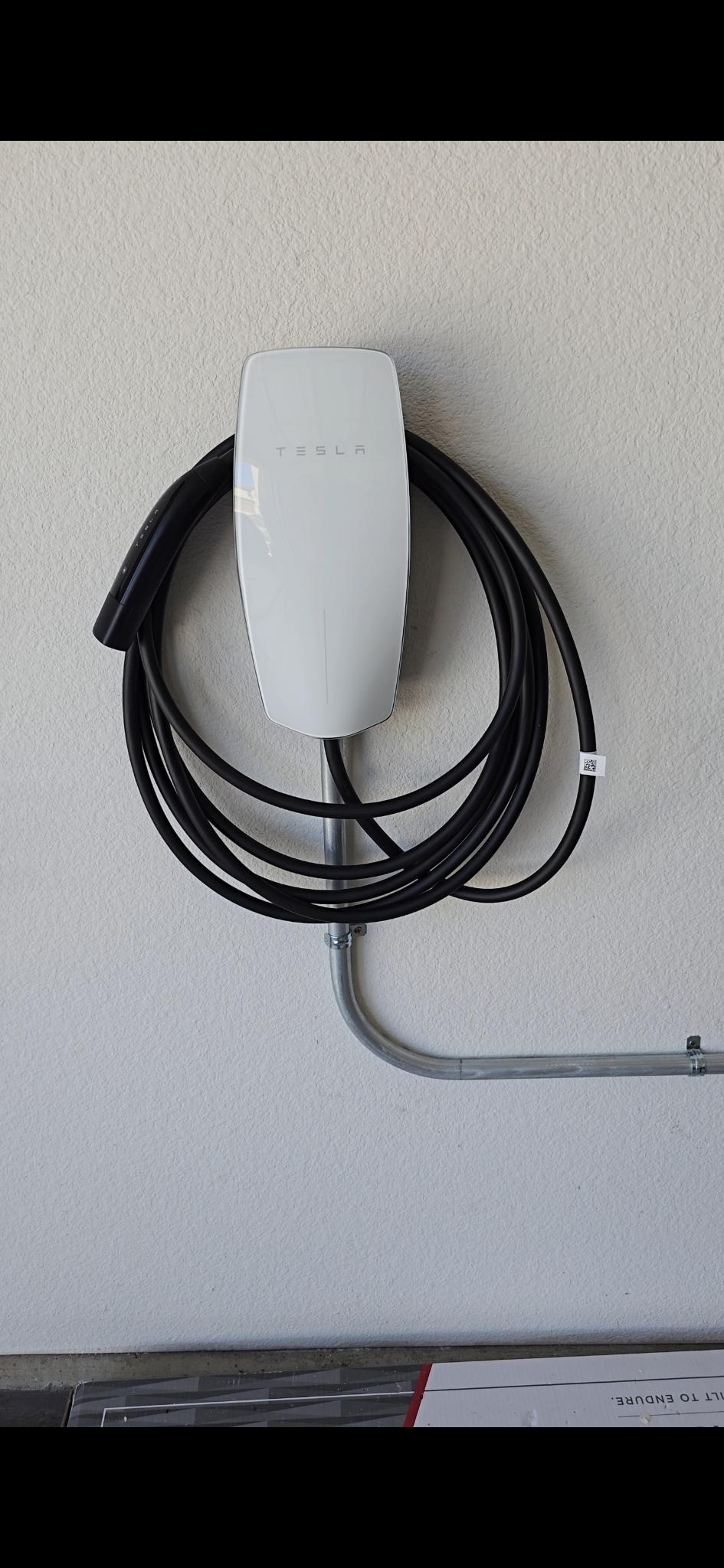 Tesla wall connector installed in a residential garage