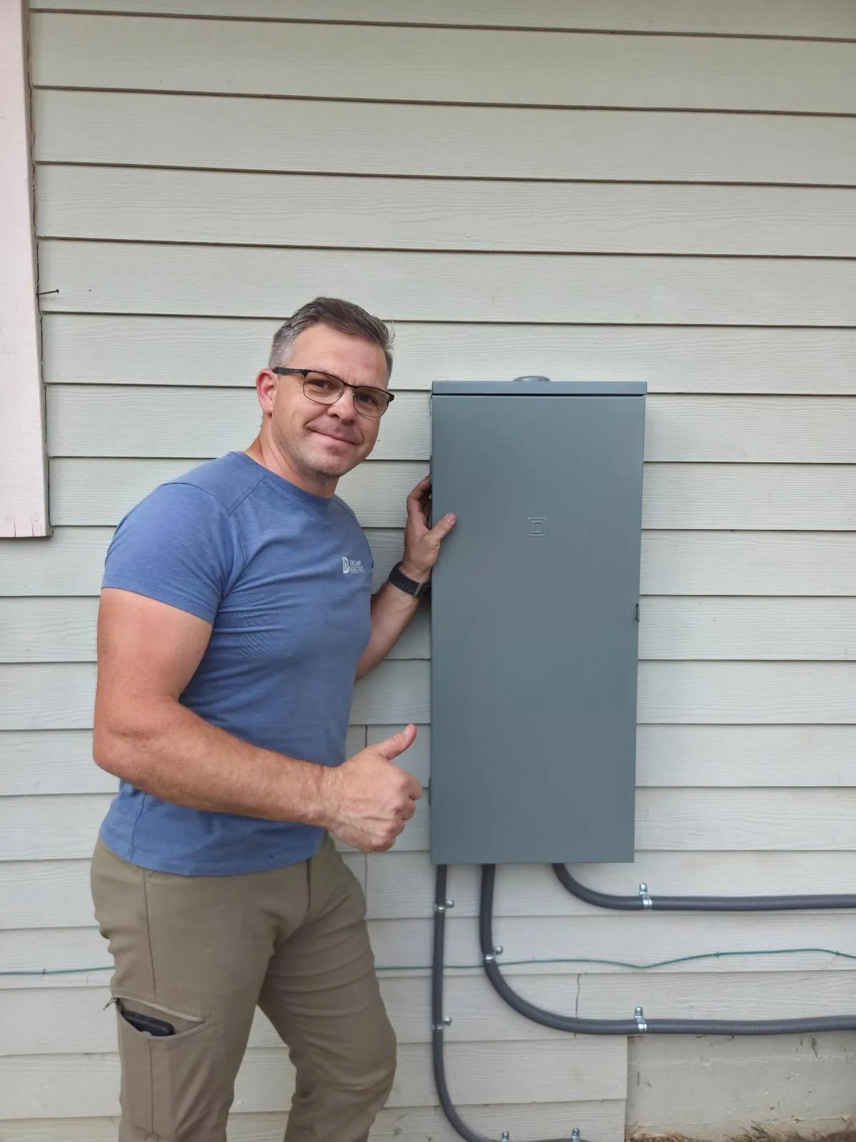 Daniel Dican beside a completed panel replacement