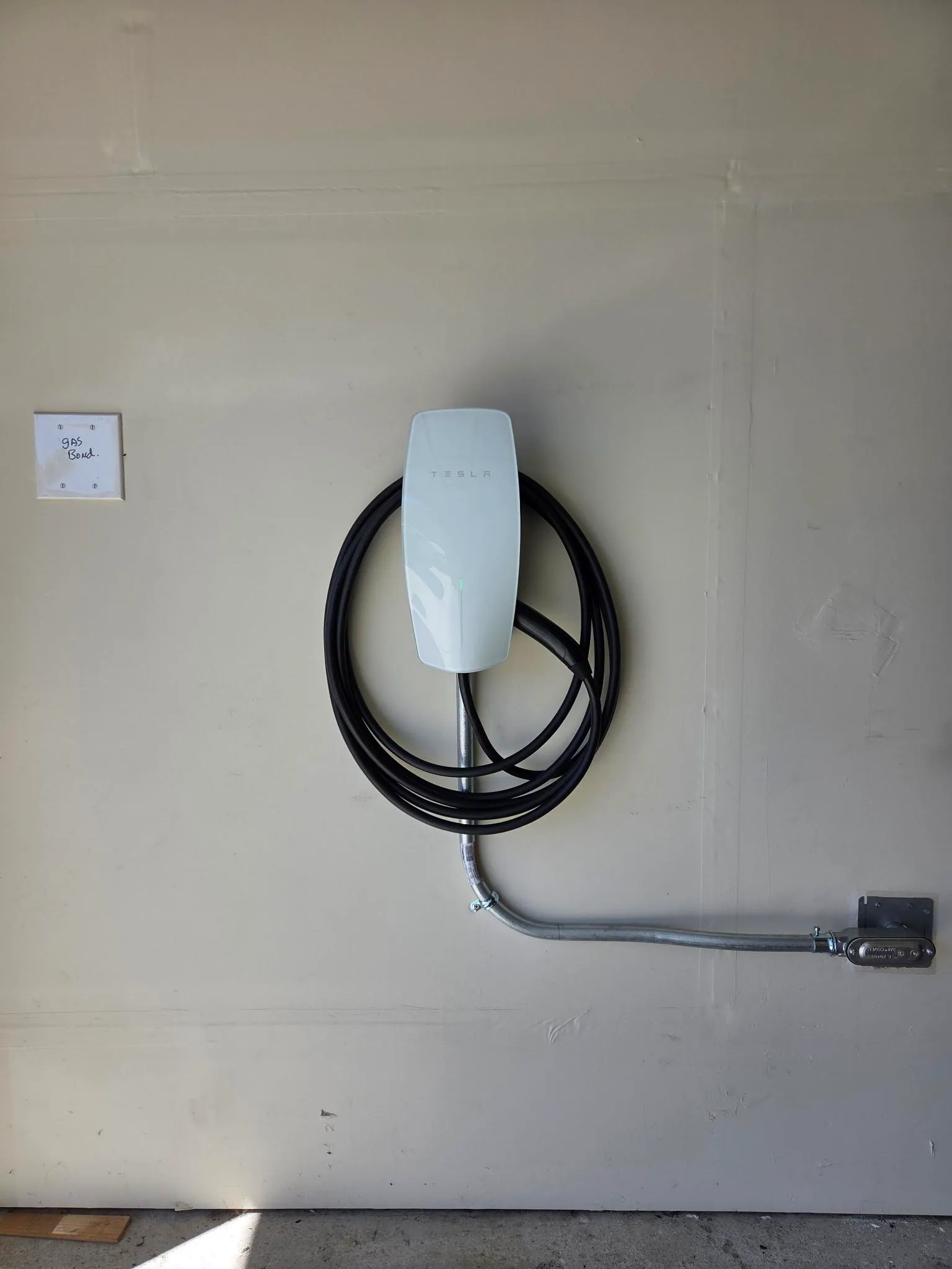 Tesla wall connector installed in a residential garage