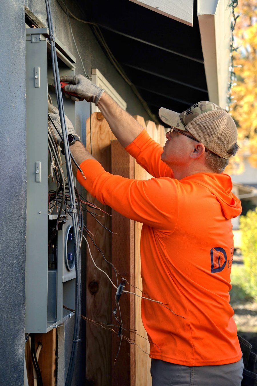 Daniel Dican working on a residential electrical panel